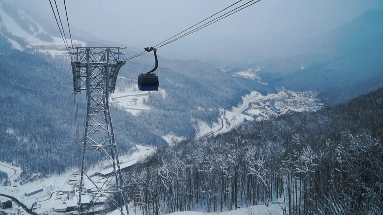 Cable cars rising over the Caucasus mountains at Rosa Khutor
